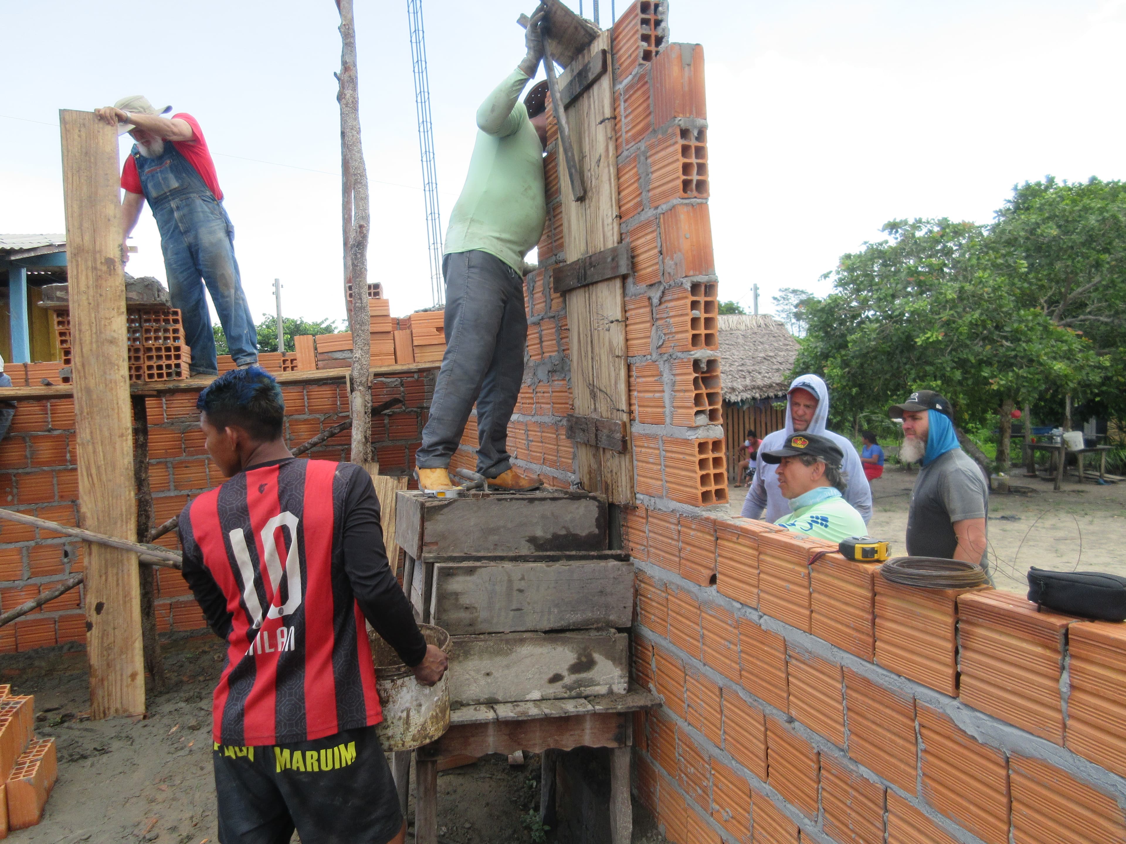 Volunteers working on brick wall